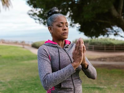 Close-up of hands in a specific yoga mudra, signifying concentration.